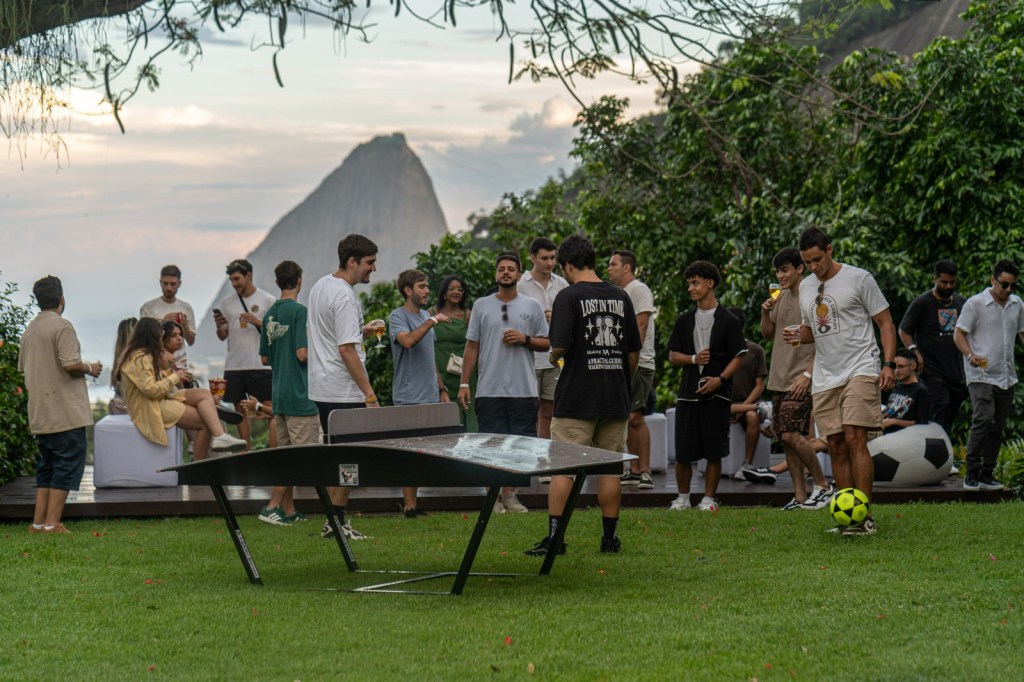 Jardins do Solar Real com convidados em evento corporativo ao ar livre e vista panorâmica para o Rio de Janeiro